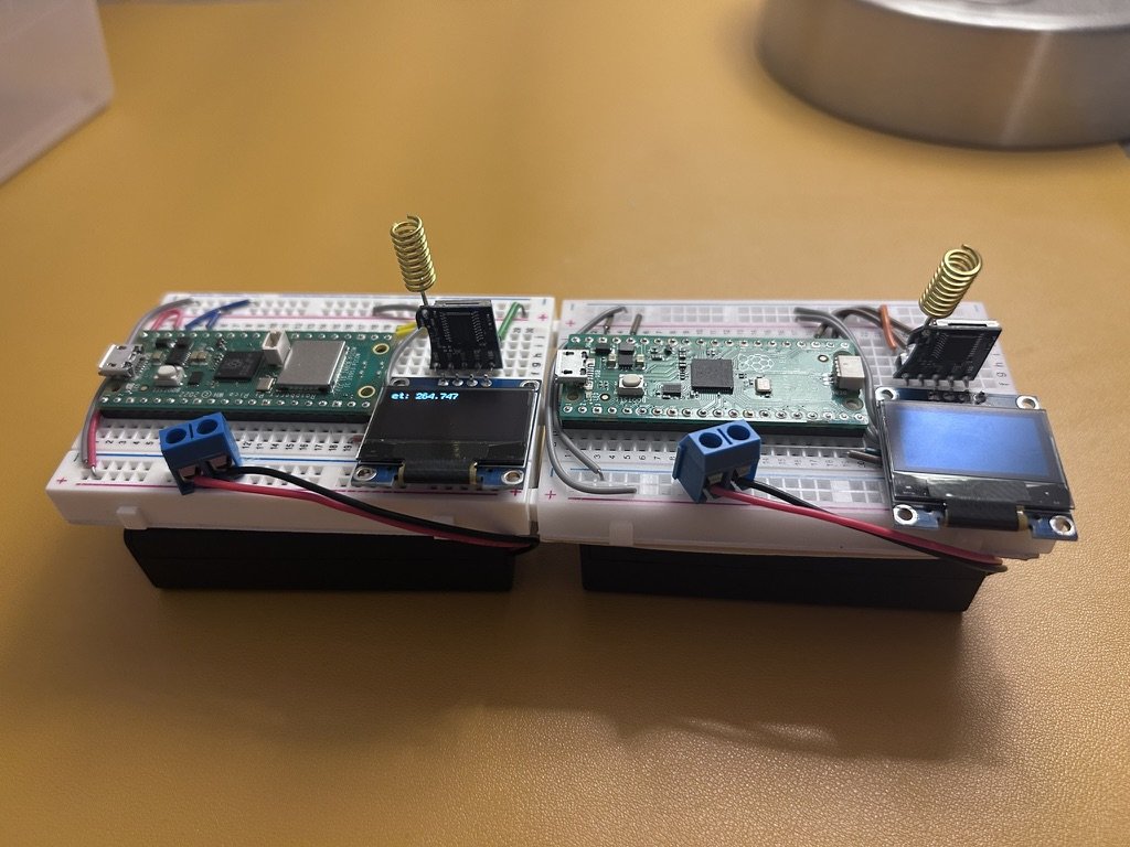 Two LoRa radio nodes on breadboards with OLED screens